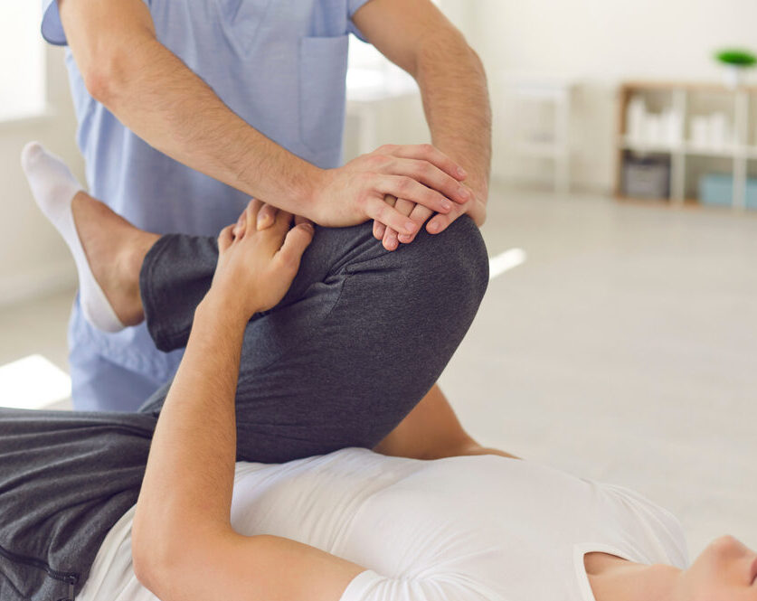 Physiotherapist performing a knee adjustment